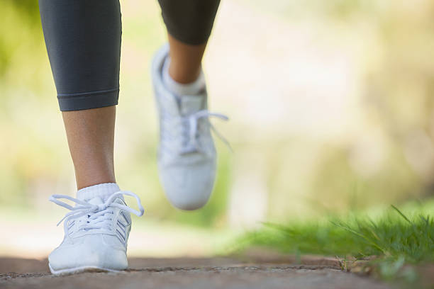istock Jogger running along a pathway in the park 498548975