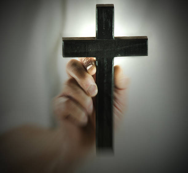 istock Black wood cross hand held, selective focus, zoom applied 498548980