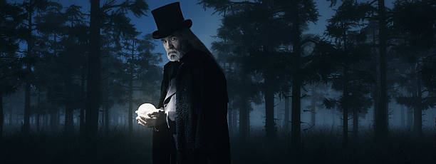 istock Illusionist Holding Illuminated Sphere in Foggy Winter Forest at Night. 498549312