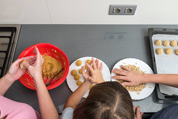 Family preparing sweets in the kitchen stock photo