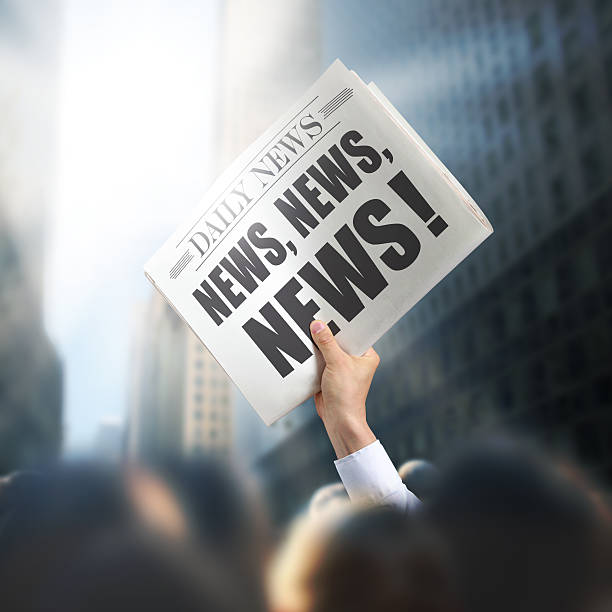 istock Holding Newspaper with News 498549837