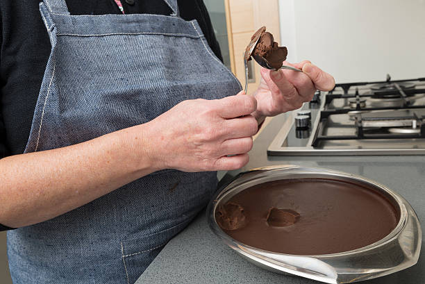 Woman preparing chocolate truffles Woman preparing chocolate truffles in the kitchen chocolate truffle making stock pictures, royalty-free photos & images