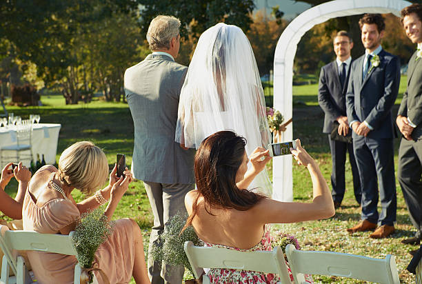 happy wedding couple in suit and white dress, hugging, walking after the ceremony.
