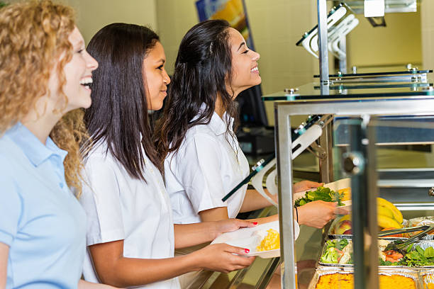 istock Girls eating lunch in private high school cafeteria 498550711