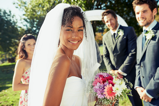 Portrait of a happy bride looking over her shoulder as she walks down the aislehttp://195.154.178.81/DATA/i_collage/pu/shoots/784347.jpg