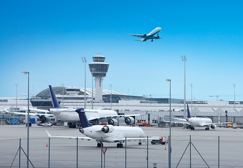 Graz, Austria – December 31, 2020: Austrian regional aircraft parked in front of terminal at airport Graz and waiting for passengers