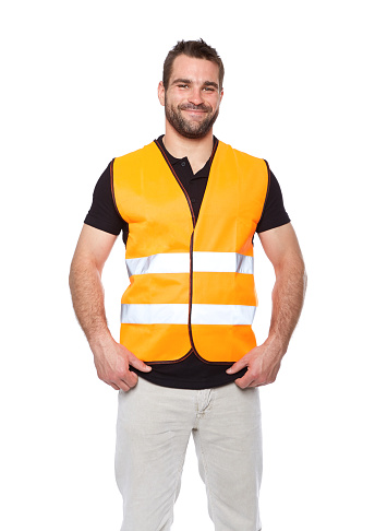 Portrait of smiling worker in a reflective vest isolated on white background
