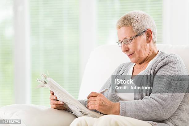 Senior Woman Reading Newspapers Stock Photo - Download Image Now - 60-64 Years, 60-69 Years, Active Lifestyle