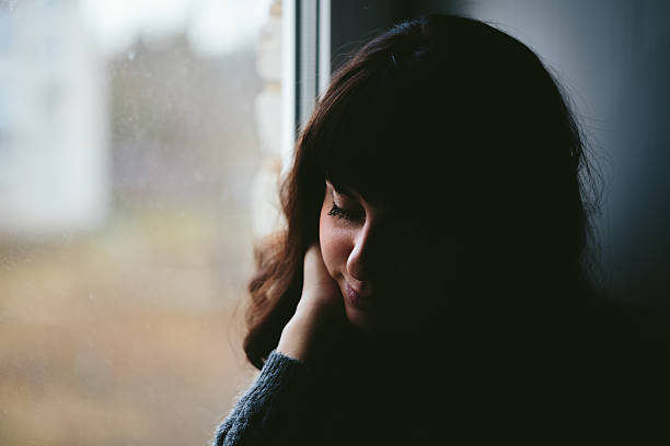 istock Young woman longs near a window 498553954