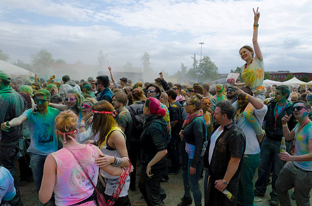 Amberg, Germany - May 17, 2014: Holi Color Festival, the colorful people throw colored powder after the countdown in the air