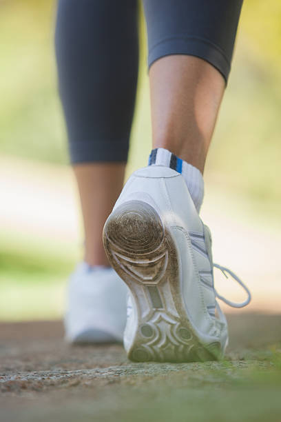 istock Woman walking along a pathway in the park 498556157