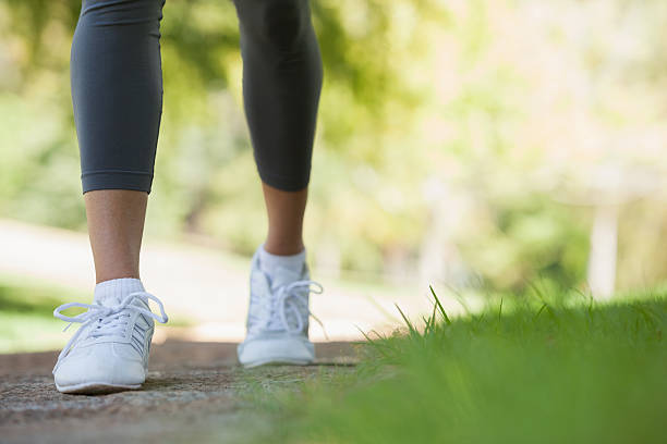 istock Woman walking along a pathway in the park 498556161