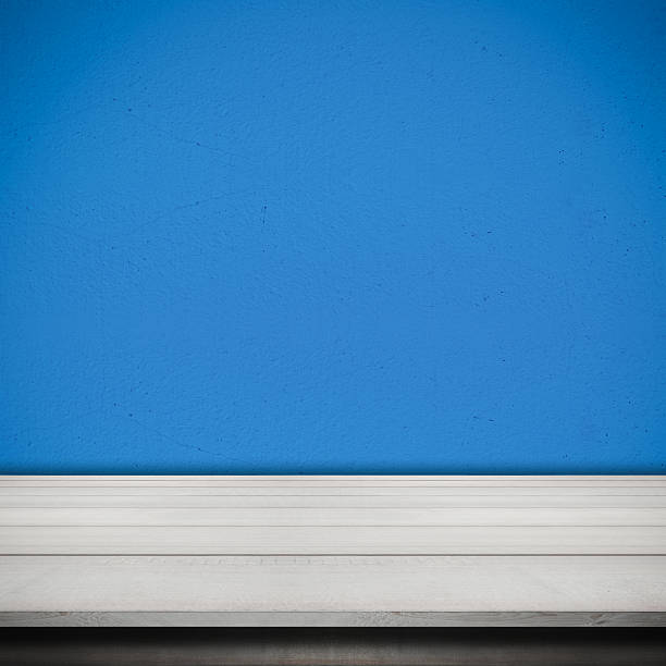 istock Cement Wall Painted Blue Color and Wood Table Desk Background 498561118