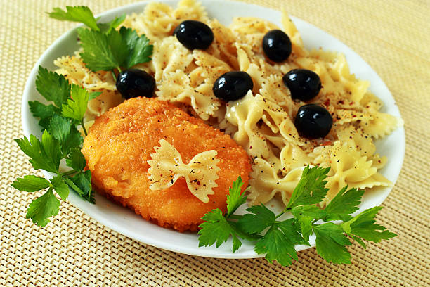 Ukrainian chicken chop of kiev and pasta with olives