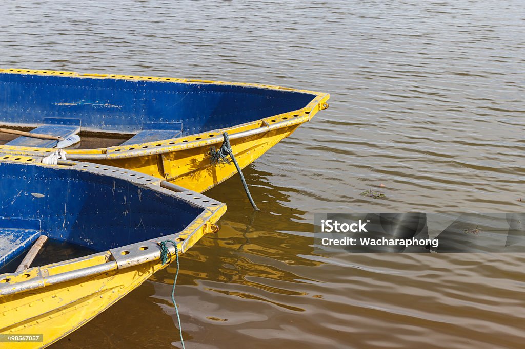 punt Yellow pontoon hulls riverbank. Blue Stock Photo