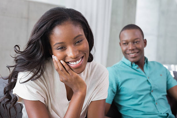 istock Happy couple sitting on the couch together 498567295