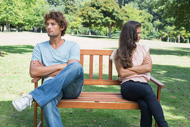 istock Couple not talking after a dispute on park bench 498567345
