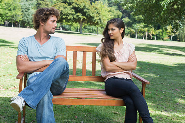 istock Couple having a dispute on park bench 498567359