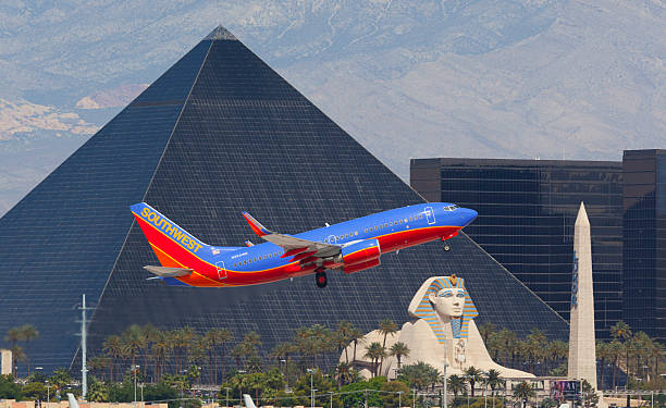 Southwest Airlines 737 Las Vegas. Paradise, Nevada, USA - May 23, 2014: A Southwest Airlines Boeing 737 takes off from McCarran International Airport just south of the Las Vegas strip. In the background is the 4,400 room Luxor Hotel and casino. las vegas pyramid stock pictures, royalty-free photos & images