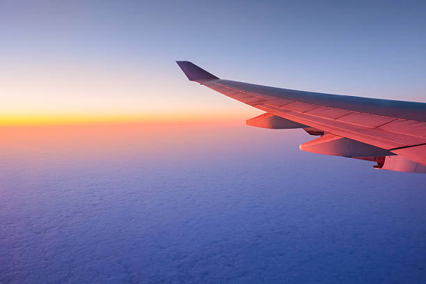 istock Airplane sunset sunrise sky view from a window 498569045
