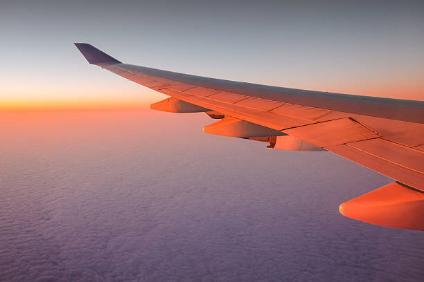 istock Airplane sunset sunrise sky view from a window 498569527