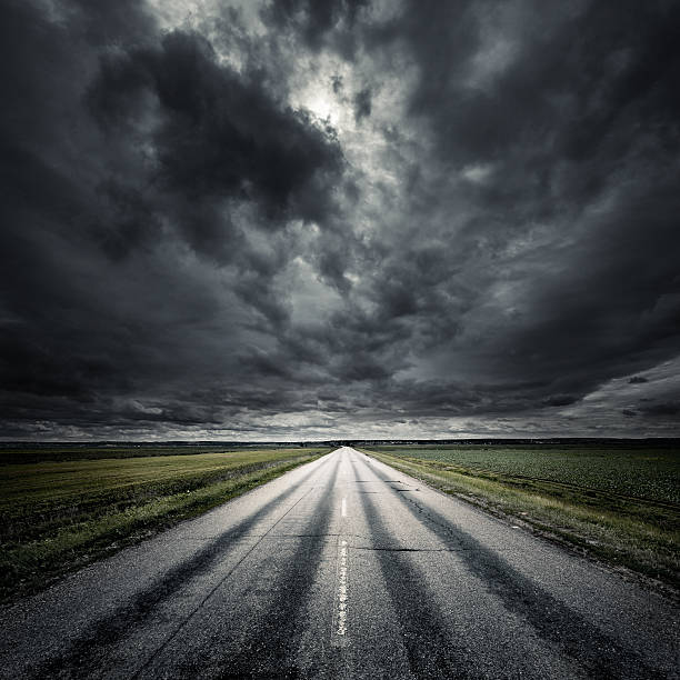 Way forward Asphalt road at storm. Forward direction. all weather running track stock pictures, royalty-free photos & images