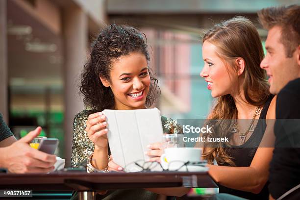 Young People Using Digital Tablet Stock Photo - Download Image Now - 20-24 Years, Adolescence, Adult