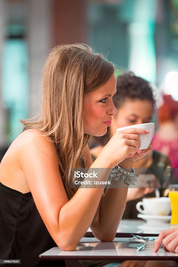 Young woman in coffee shop Close up of young woman drinking coffee in coffee shop. 20-24 Years Stock Photo