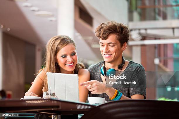 Couple Using Digital Tablet Stock Photo - Download Image Now - 20-24 Years, Adolescence, Adult