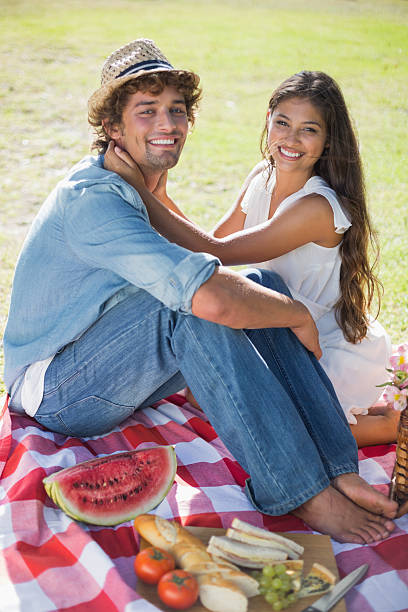 istock Young couple having a romantic picnic in the park 498572409