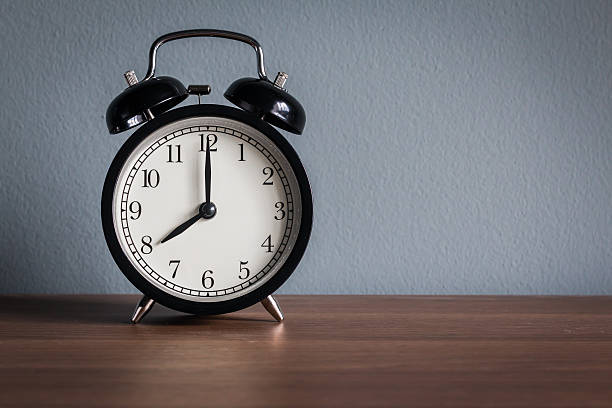 istock Still life with vintage alarm clock on wood table 498572852