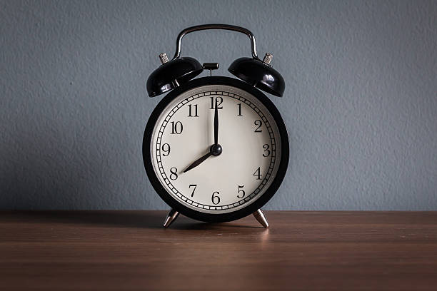 istock Still life with vintage alarm clock on wood table 498572898