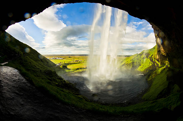 istock Cave behind Seljalandsfoss waterfall,river Seljalandsa,Iceland 498574372