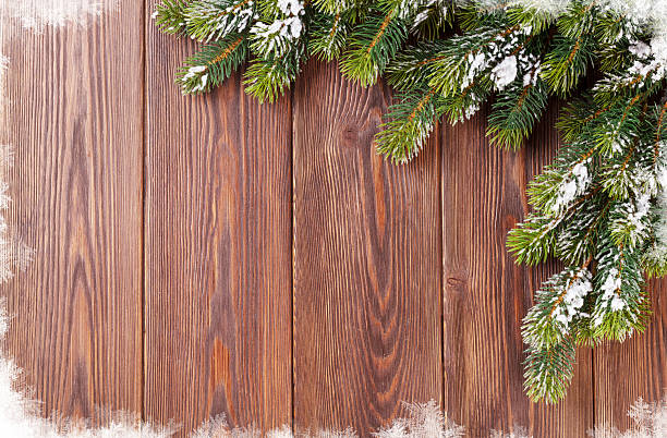 istock Christmas wooden background with snow fir tree 498576066