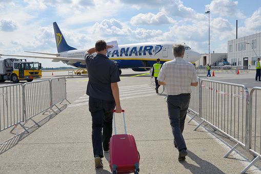 Maastricht, Netherlands - September 8, 2013: People go towards the Ryanair aircraft during boarding. Ryanair will carry 81.5 million passengers this year