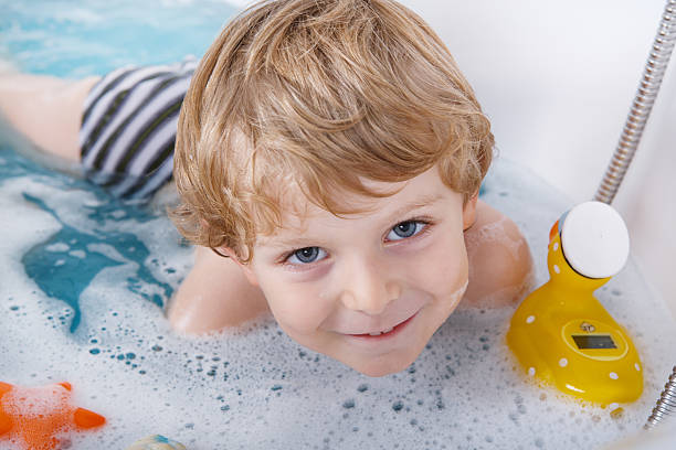 istock Cute little toddler boy having fun by taking bath 498577299