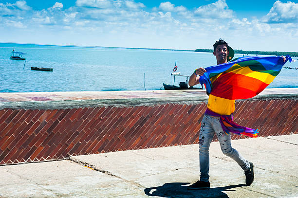 Man walking with rainbow flag stock photo