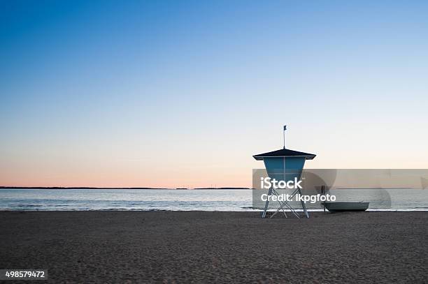 Lifeguard Tower And A Boat On The Beach At Sunset Stock Photo - Download Image Now - 2015, Arrangement, Back Lit