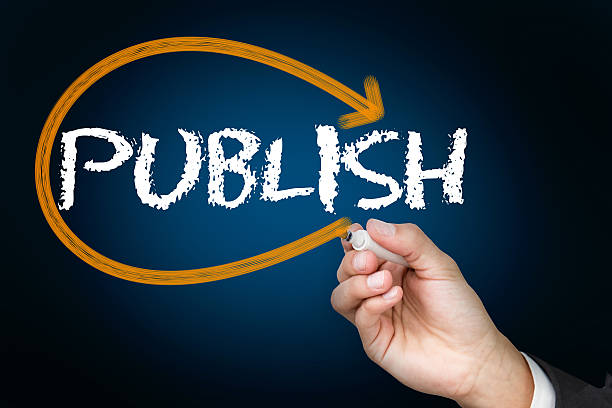istock Businessman writing publish against blue background 498579959
