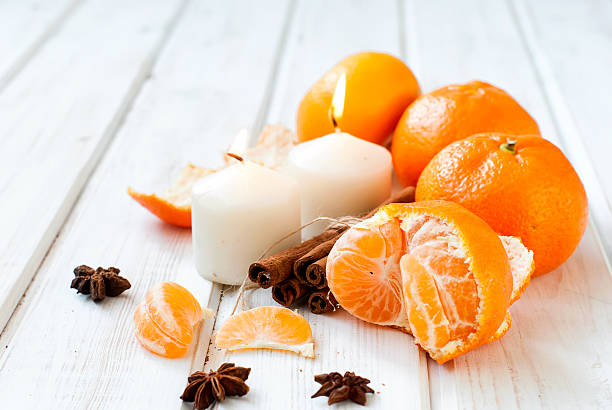 istock tangerines, cinnamon sticks, star anise and candle - Christmas m 498580320