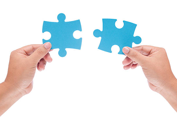 istock man hand holding jigzaw isolated on white background 498580754
