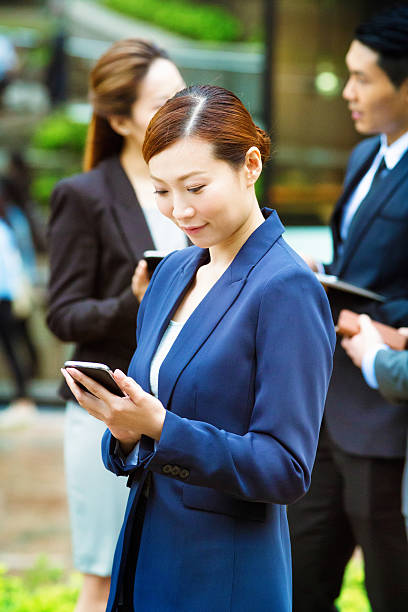 istock Chinese businesswoman text messaging by herself 498580883
