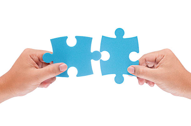 istock man hand holding jigzaw isolated on white background 498581070