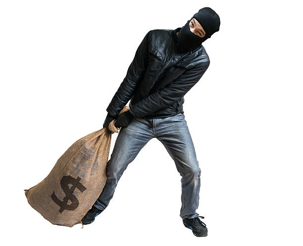 istock Thief or robber pulling loot - bag full of money 498581176