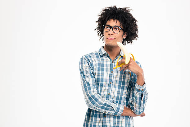 istock Thoughtful afro american man holding banana 498582626