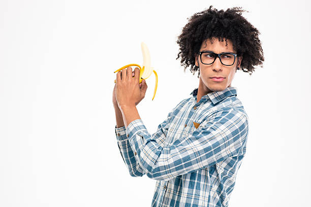 istock Funny afro american man holding banana 498582710