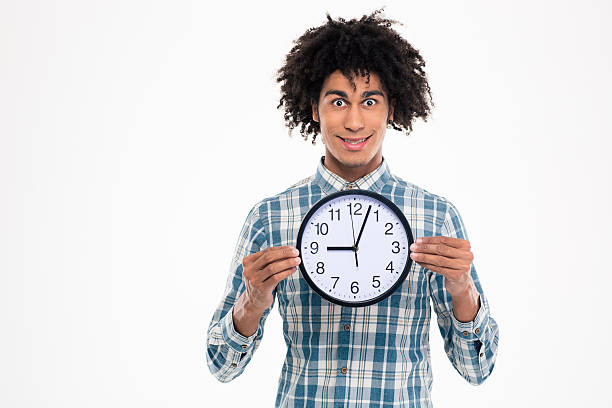 istock Happy afro american man holding wall clock 498583126
