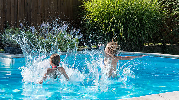 istock Girls jumping in swimming pool 498585422