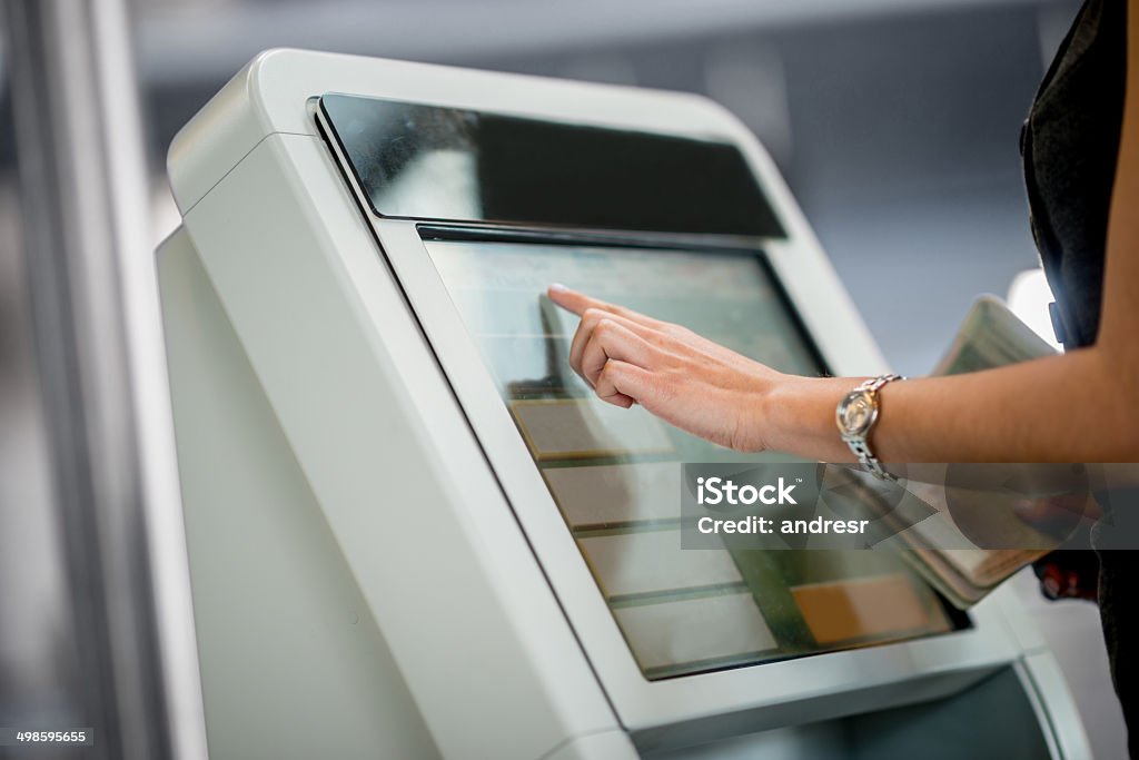 Online check-in People traveling and doing online check-in at the airport Kiosk Stock Photo