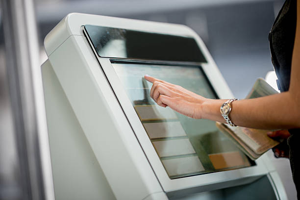 Online check-in People traveling and doing online check-in at the airport kiosk stock pictures, royalty-free photos & images